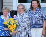 ARCS Ligth Recipient Mary Jo Ruane receiving a a bouget of flowers.